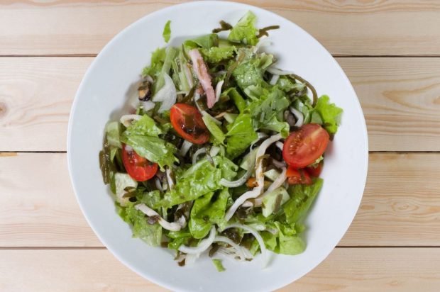 Seafood salad, sea cabbage and fresh vegetables