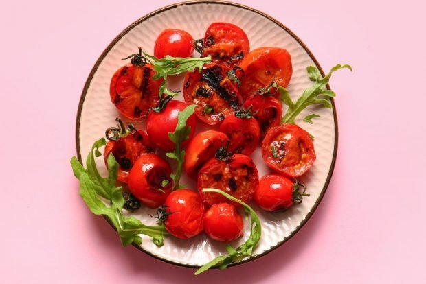 Tomatoes on the barbecue on the grille Tomatoes on the barbecue on the grille