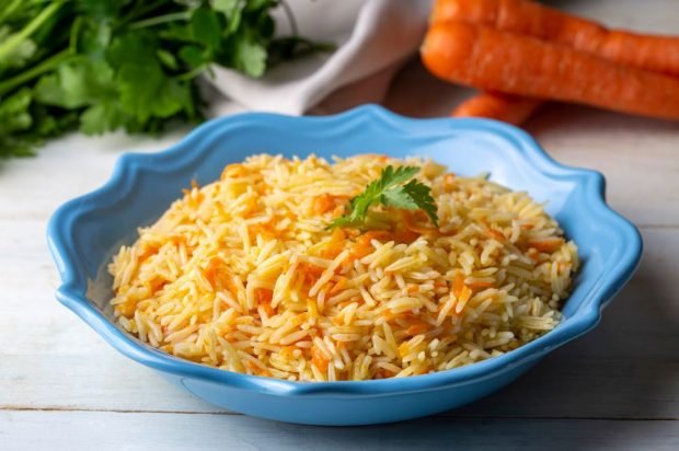 Vegetarian pilaf with carrots and spices in a slow cooker